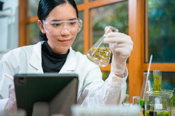 Asian woman scientist plant science laboratory research, biological chemistry test, green nature organic leaf experiment in test tube.