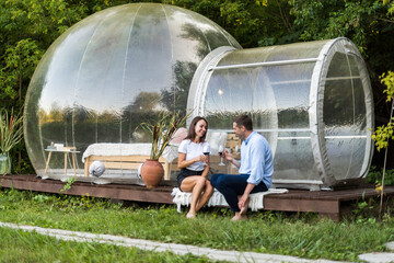 Couple drinking wine at glamping