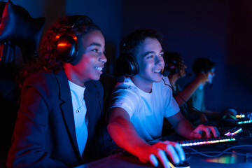 Teens playing in video game club