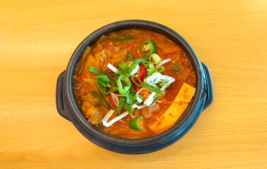 Kimchi stew with pork (Kimchijjigae) soup - Korean style on wooden table, top view