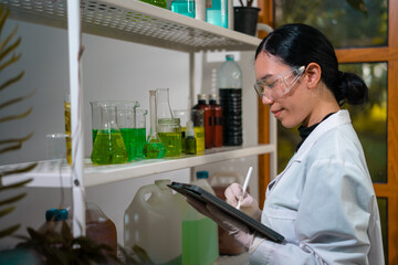 Fototapeta premium Scientist female researching with plant biotechnology concept with in laboratory. 