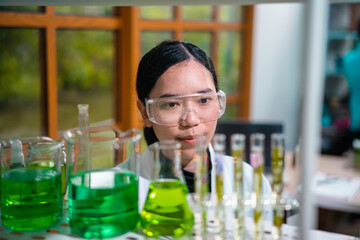 Asian woman scientist plant science laboratory research, biological chemistry test, green nature organic leaf experiment in test tube.