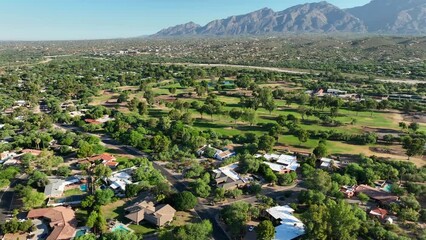 Luxury neighborhood in southwest USA. Aerial shot reveals golf course and mountains in distance. - Powered by Adobe