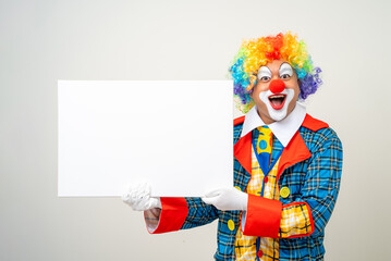 Mr Clown. Portrait of Funny face Clown man in colorful uniform standing holding copy space. Happy expression male bozo in various pose with frame mockup blank space on isolated background.