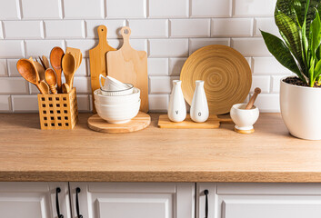 Fototapeta na wymiar Many different items of kitchen wooden utensils on a wooden countertop. Eco items. kitchen background.