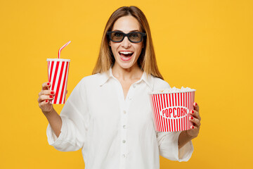 Young satisfied excited shocked fun woman in 3d glasses wear white casual clothes watch movie film hold bucket of popcorn cup of soda pop in cinema isolated on plain yellow background studio portrait