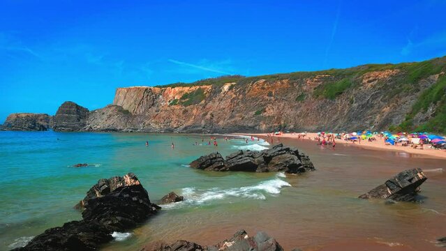 Holiday destinations in Portugal. Families enjoying Praia da Am&aacute;lia Beach