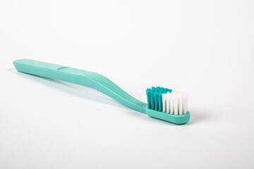 Green toothbrush on a white background. Object, dental hygiene