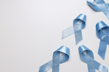 Blue satin ribbons on light background, Movember concept