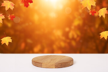 Wooden podium or pedestal on maple leaves autumn fall background. Mock up for your products.