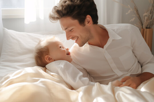 A photo of father playing with baby in bed, light white and light brown, smooth and shiny