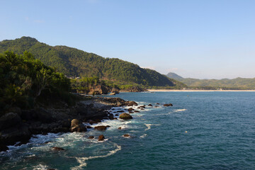 Fototapeta na wymiar rocky coast with blue water and small wave