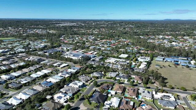 Drone orbiting shot of Narangba Brisbane Queensland Suburb. Narangba Valley State High School and town in shot. Clear mid day shot.