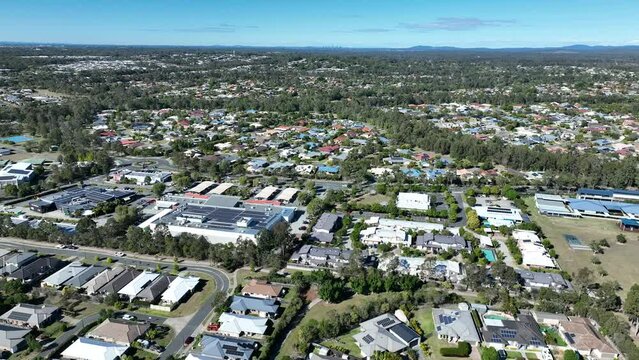 Drone pull away tracking shot of Narangba Brisbane Queensland Suburb. Town centre in shot. Brisbane Queensland Australia.