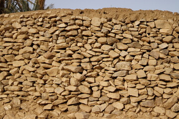 Ancient wall made of stones of different shapes Rural northern Sudan