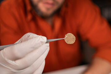 Treasure hunt and archeology, archaeologist with find rare Gold coins working at night in office