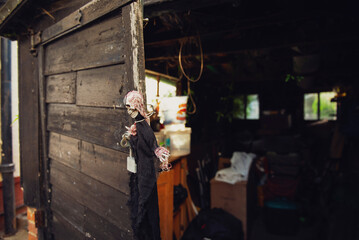 scary witch hanging on an old wooden door, Halloween