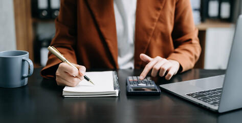 Bussinessman analyzing sales data and economic growth and pointing at business report document with graph chart financial chart marketing, banking and payments at modern office