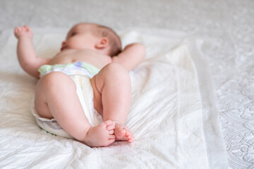 Infant feet stealing the show on soft bedding. Concept of life's gentle introductions