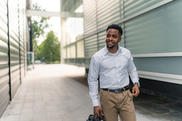 A young African-American man, ready to head home after work, puts his headphones on, immersing himself in music to enjoy his journey back home. 