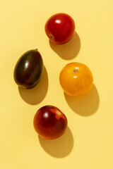 Yellow, green, red and black cherry tomatoes. Close-up.