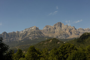 Mountainous landscape in summer with valley and vegetation.