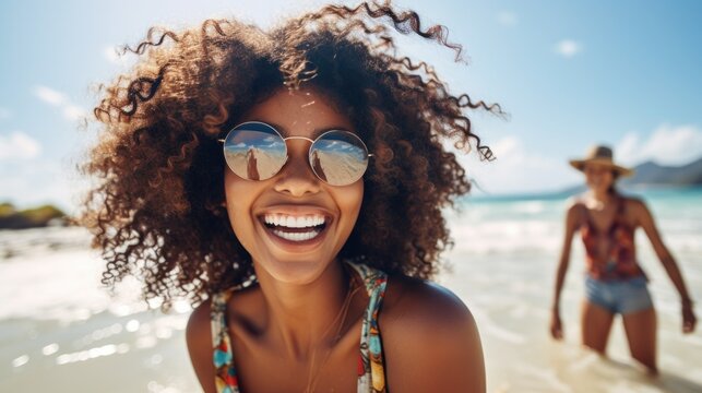 Young black woman having fun at beach with best friend. Cheerful friends enjoying at sea.
