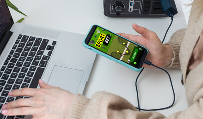 Young attractive woman showing sincere excitement about victory in online lottery. Girl being happy winning a bet in online sport gambling application on her mobile phone