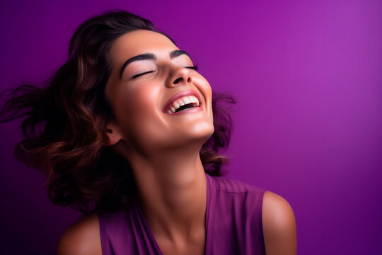 female model smiles in studio on violet background. happy model. Feminist mythology, purple and violet represent women's fight for equality and against discrimination.