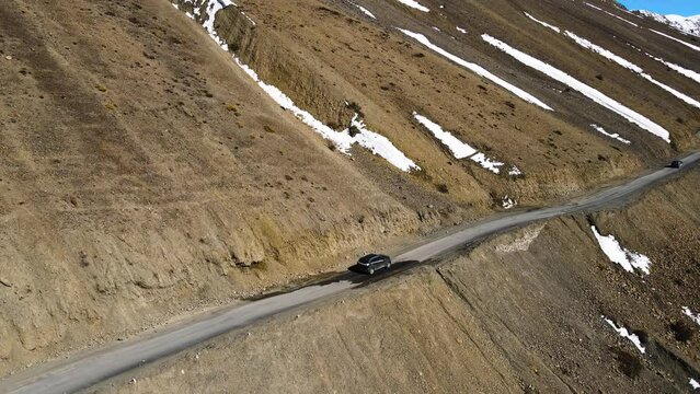 aerial drone follow jeep 4x4 in spiti valley himachal pradesh Himalaya India 