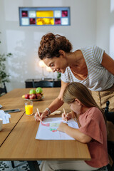 Mother and daughter drawing together