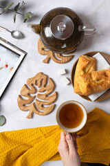 Wooden coasters for hot drinks in the shape of a monstera leaf. Decorative element, natural wood. view from above