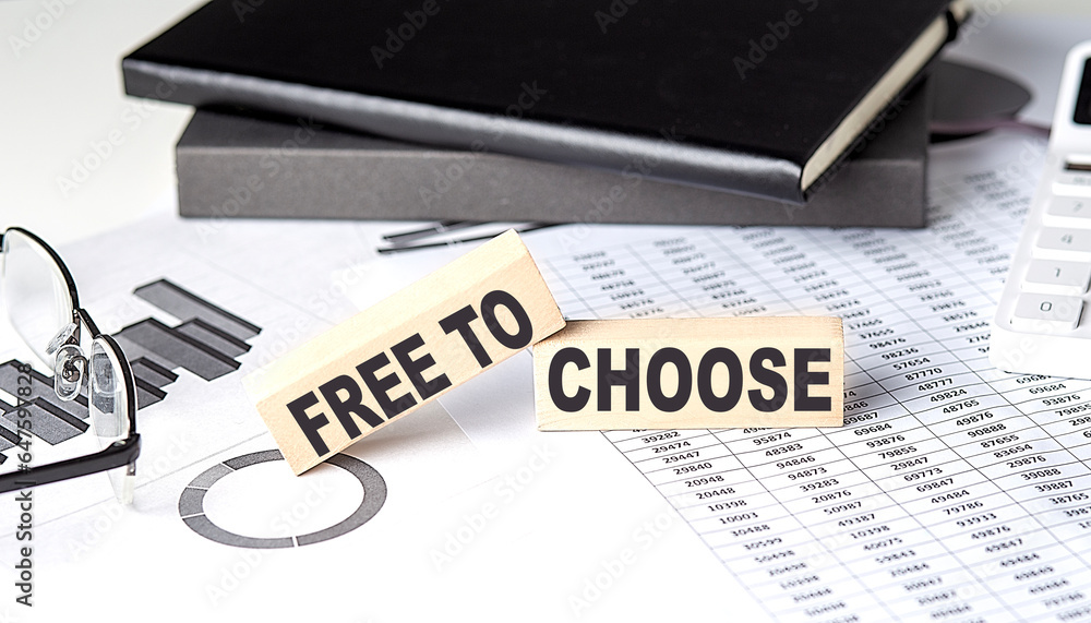 Poster free to choose - text on a wooden block with chart and notebook