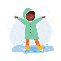 Happy black child in the puddle enjoying rainy weather