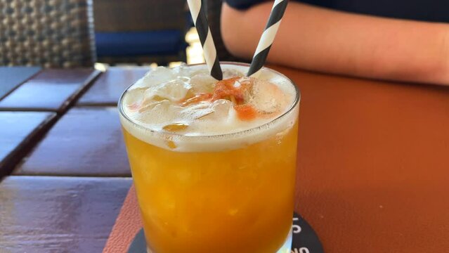Delicious summer fruity cocktail in a restaurant, cold refreshing drink, 4K shot