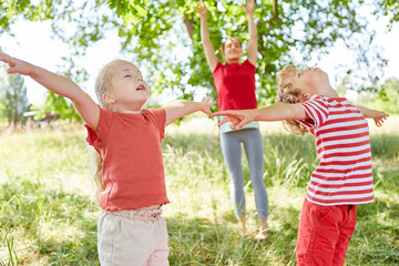 Family doing breathing exercise in garden