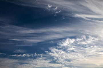 Obraz premium Whimsical Cloudscape: Fluffy Clouds, Cornfield, and Gravel Road After the Storm