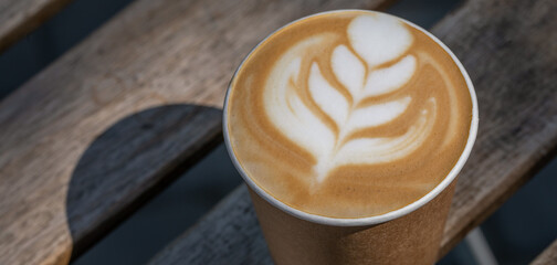 Caffeine Comfort: Macro Shot of Latte in a Park's Peaceful Embrace