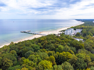 Aerial view landscape, view of Baltic sea in Poland, clean beach, forest and trees, horizon.