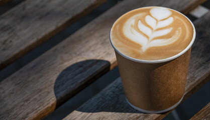 Latte Love: A Paper Cup Rests on a Park Bench, Sharp Focus