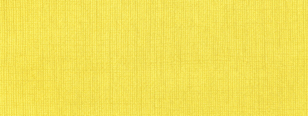 Texture of bright yellow color background from textile with wicker pattern, macro. Vintage lemon...