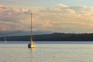 A boat rocks on the lake before sunset in pleasant late summer weather.