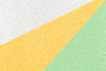 Texture of old craft white, yellow and green pastel color paper background, macro. Vintage abstract...