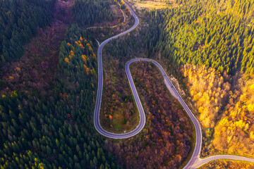 Autumn's Aerial Beauty: Serene Mountains and a Meandering Road