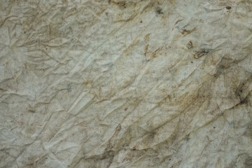 background of a fabric from a piece of crumpled white gray dirty cloth