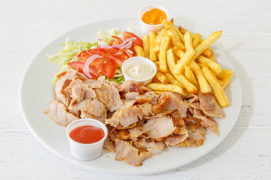 Assiette de doner kebab avec des frites et l&eacute;gumes. Les sauces aux choix. 