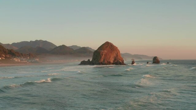 Low dolly forward aerial shot towards Haystack rock Oregon