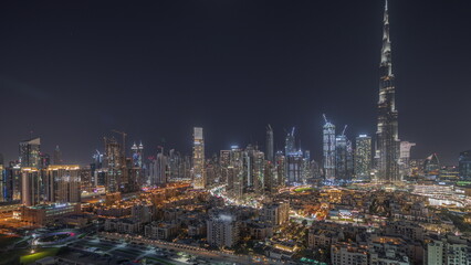 Fototapeta premium Panorama showing Dubai's business bay towers aerial night timelapse. Rooftop view of some skyscrapers