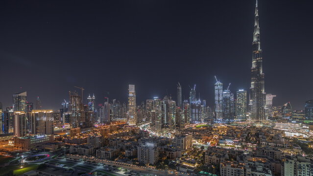 Panorama Showing Dubai's Business Bay Towers Aerial Night Timelapse. Rooftop View Of Some Skyscrapers