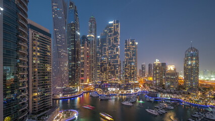 Fototapeta na wymiar Dubai marina tallest skyscrapers and yachts in harbor aerial day to night timelapse.